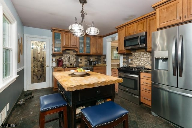 50 Skillman Rd, Montgomery Twp, NJ 08558 - kitchen featuring stainless steel appliances, brown cabinets, decorative backsplash, and healthy amount of natural light