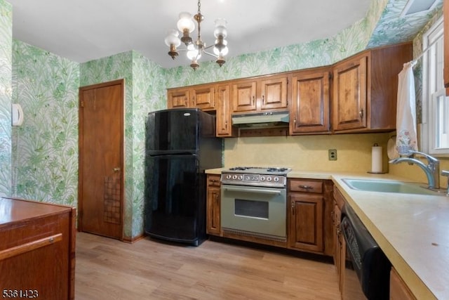 3 Gregory Ter, Belleville Twp, NJ 07109 - kitchen featuring wallpapered walls, black appliances, a sink, brown cabinetry, and under cabinet range hood