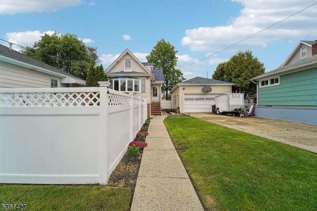 30 Market St, Garfield City, NJ 07026 - view of yard featuring an outdoor structure, a detached garage, and concrete driveway