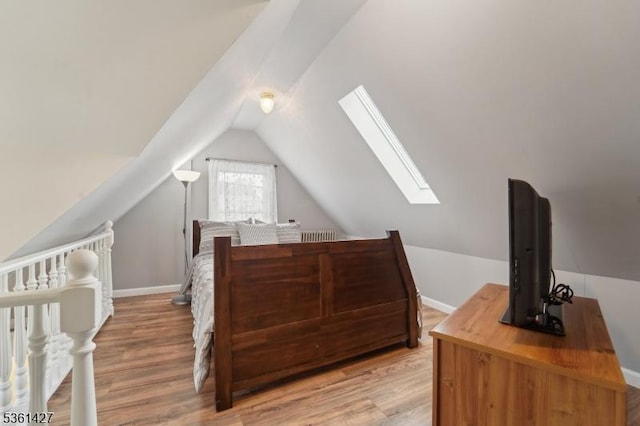 30 Market St, Garfield City, NJ 07026 - bedroom featuring a skylight, vaulted ceiling, light wood-style floors, and baseboards