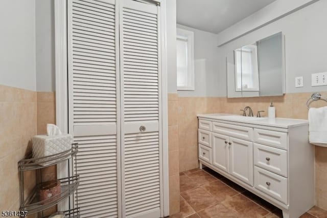 30 Market St, Garfield City, NJ 07026 - bathroom with tile walls, vanity, tile patterned floors, wainscoting, and a closet