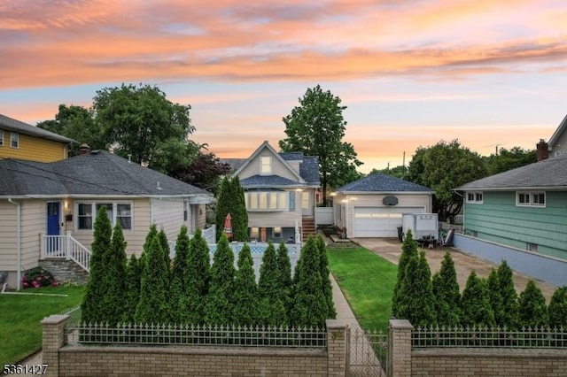 30 Market St, Garfield City, NJ 07026 - view of front of home featuring a garage, a fenced front yard, an outbuilding, and a gate