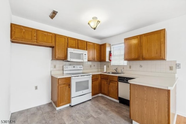 239 40th St Unit 7, Irvington Twp, NJ 07111 - kitchen featuring white appliances, a sink, decorative backsplash, and brown cabinets