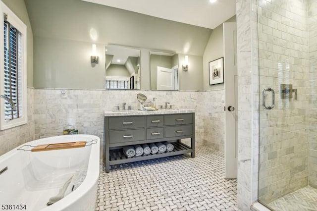 100 Gregory Ave, West Orange Twp, NJ 07052 - bathroom featuring tile walls, a shower stall, double vanity, a bath, and a wainscoted wall