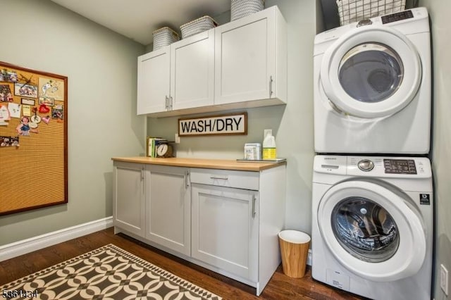 100 Gregory Ave, West Orange Twp, NJ 07052 - washroom with stacked washer and clothes dryer, cabinet space, dark wood-type flooring, and baseboards