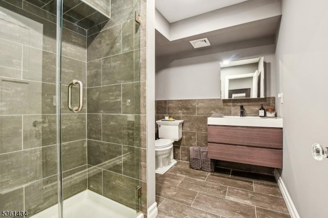 100 Gregory Ave, West Orange Twp, NJ 07052 - bathroom with vanity, toilet, a stall shower, and tile walls