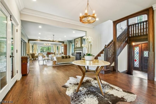 100 Gregory Ave, West Orange Twp, NJ 07052 - entryway featuring a chandelier, ornamental molding, french doors, a fireplace, and wood finished floors