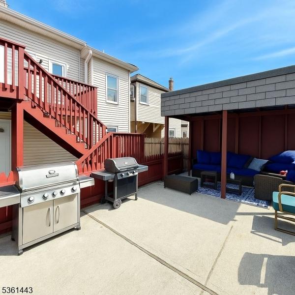 276 5th Ave, Paterson City, NJ 07524 - view of patio featuring a grill, an outdoor hangout area, and stairs