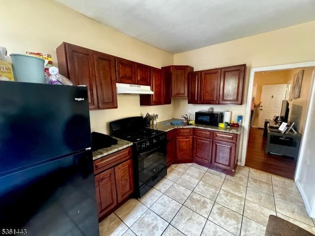 276 5th Ave, Paterson City, NJ 07524 - kitchen featuring black appliances, under cabinet range hood, a sink, light tile patterned floors, and stone countertops