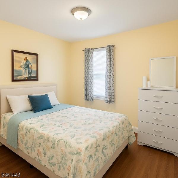 276 5th Ave, Paterson City, NJ 07524 - bedroom with dark wood-style flooring and baseboards