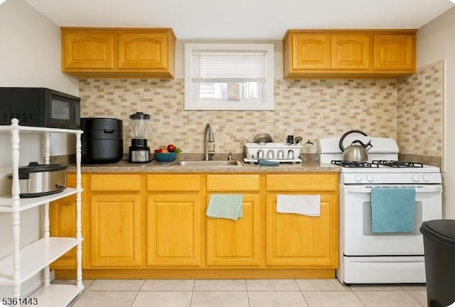 276 5th Ave, Paterson City, NJ 07524 - kitchen featuring white gas range, black microwave, a sink, and decorative backsplash