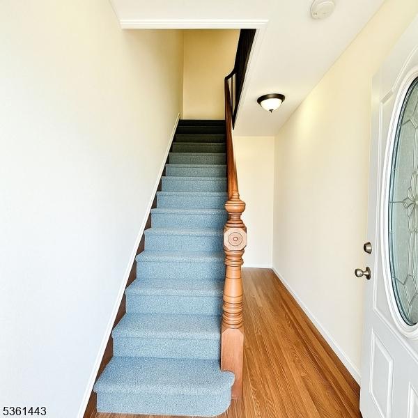 276 5th Ave, Paterson City, NJ 07524 - stairs with wood finished floors and baseboards