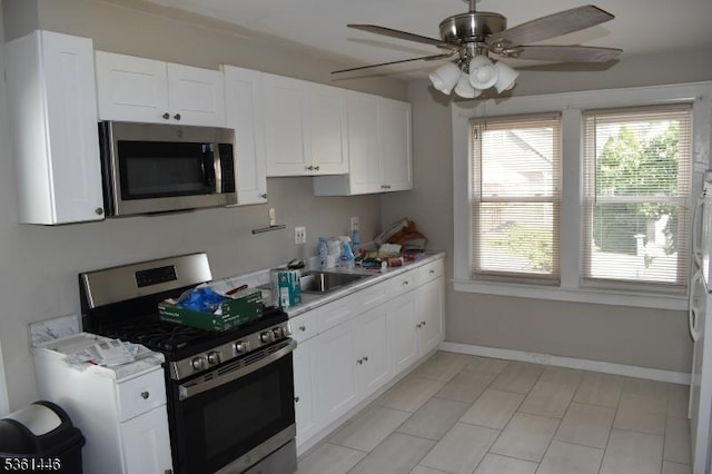 375 Tower St, Union Twp, NJ 07088 - kitchen with appliances with stainless steel finishes, white cabinets, light countertops, ceiling fan, and plenty of natural light