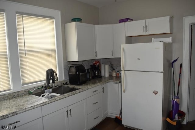 375 Tower St, Union Twp, NJ 07088 - kitchen featuring freestanding refrigerator, a sink, white cabinets, and light stone countertops