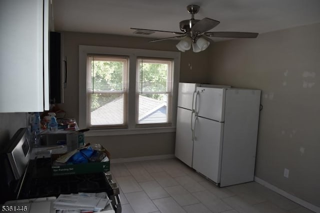 375 Tower St, Union Twp, NJ 07088 - kitchen with freestanding refrigerator, white cabinetry, ceiling fan, baseboards, and light tile patterned flooring