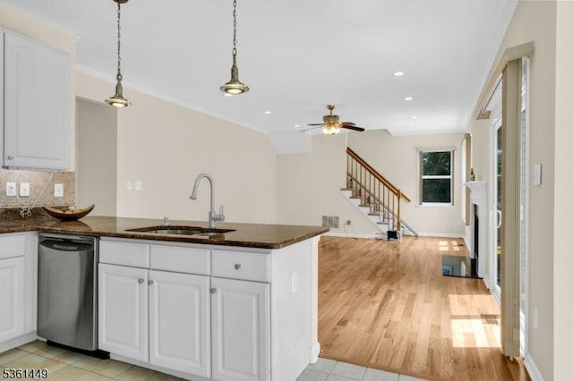 9 Mcgovern Ct, Bridgewater Twp, NJ 08807 - kitchen with stainless steel dishwasher, a ceiling fan, a peninsula, white cabinets, and recessed lighting