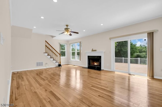 9 Mcgovern Ct, Bridgewater Twp, NJ 08807 - unfurnished living room with light wood-style flooring, stairs, a high end fireplace, recessed lighting, and a ceiling fan