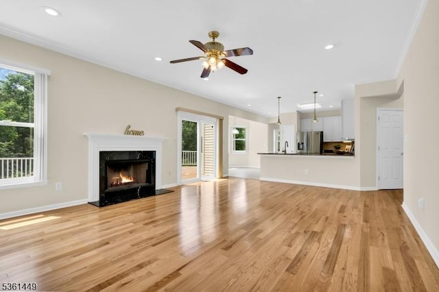 9 Mcgovern Ct, Bridgewater Twp, NJ 08807 - unfurnished living room with healthy amount of natural light, light wood-style floors, a high end fireplace, a ceiling fan, and recessed lighting