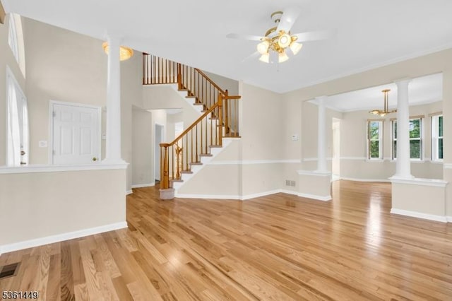9 Mcgovern Ct, Bridgewater Twp, NJ 08807 - unfurnished living room with ornate columns, stairs, ceiling fan, and light wood-style floors