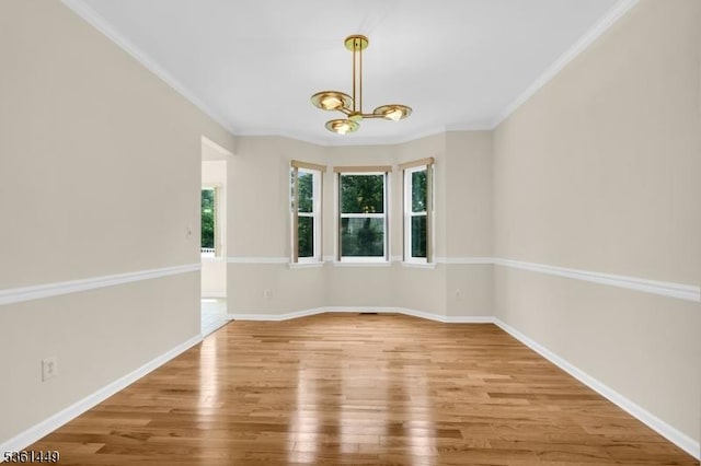 9 Mcgovern Ct, Bridgewater Twp, NJ 08807 - spare room featuring wood finished floors, a chandelier, and crown molding