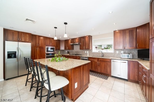 32 Fairway Ave, West Orange Twp, NJ 07052 - kitchen featuring stainless steel appliances, tasteful backsplash, light tile patterned floors, light stone counters, and a center island