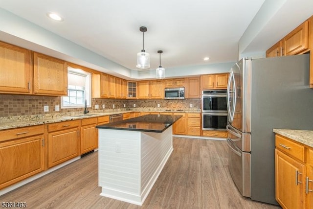 5 Britton St, Netcong Boro, NJ 07857 - kitchen with stainless steel appliances, a sink, light wood-style flooring, decorative backsplash, and light stone counters