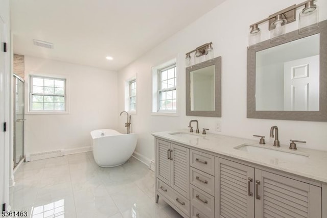 5 Britton St, Netcong Boro, NJ 07857 - full bathroom with plenty of natural light, double vanity, a freestanding bath, a shower stall, and recessed lighting