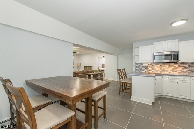 5 Britton St, Netcong Boro, NJ 07857 - dining room with dark tile patterned flooring, a baseboard radiator, and baseboards