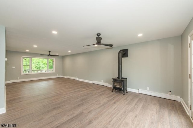 5 Britton St, Netcong Boro, NJ 07857 - unfurnished living room with a ceiling fan, a baseboard radiator, a wood stove, wood finished floors, and recessed lighting