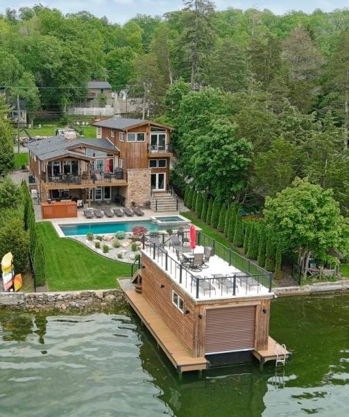 72 E Shore Trl, Sparta Twp, NJ 07871 - dock with a forest view, a deck with water view, a pool with connected hot tub, and a patio area