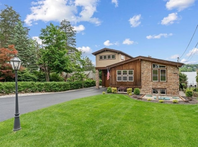 72 E Shore Trl, Sparta Twp, NJ 07871 - view of front facade with stone siding, a front lawn, and driveway