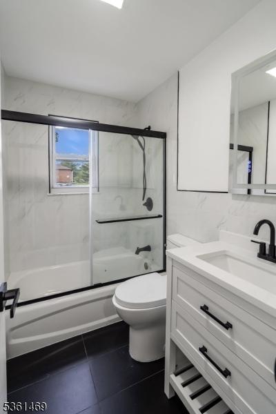 16 Deanna Dr Unit 23, Hillsborough Twp, NJ 08844 - full bathroom with vanity, bath / shower combo with glass door, tile patterned flooring, and toilet