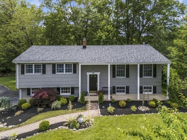 1730 Arrowbrook Dr, Bridgewater Twp, NJ 08836 - bi-level home featuring roof with shingles, a front yard, a porch, and a chimney