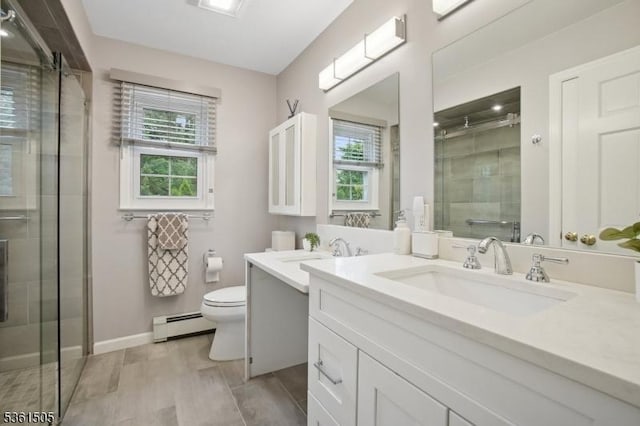 52 Hawthorne Ave, Springfield Twp, NJ 07081 - bathroom with a baseboard heating unit, a stall shower, vanity, toilet, and baseboards