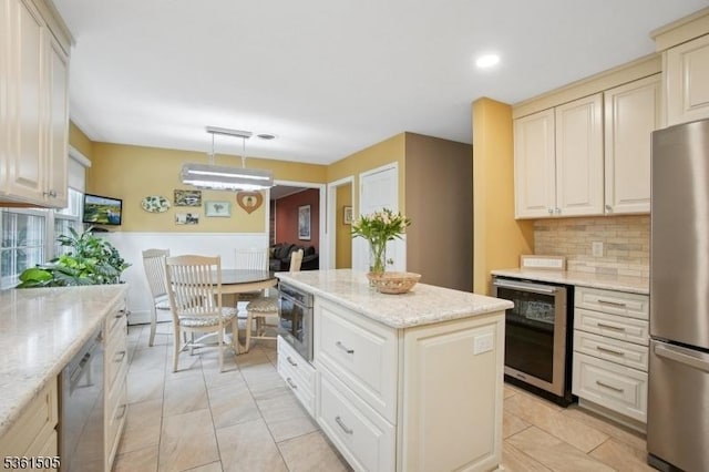 52 Hawthorne Ave, Springfield Twp, NJ 07081 - kitchen featuring wine cooler, stainless steel appliances, a kitchen island, backsplash, and light stone counters