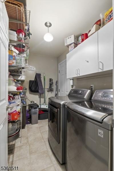 5 Caleb Ct, Hardyston Twp, NJ 07419 - laundry room featuring cabinet space, separate washer and dryer, and light tile patterned floors
