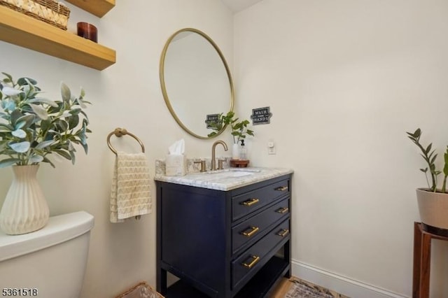 59 Eaton Pl, Bloomfield Twp, NJ 07003 - bathroom featuring toilet, vanity, and baseboards