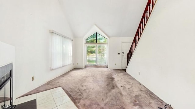 301 Smithwold Rd, Franklin Twp, NJ 08873 - unfurnished living room featuring carpet flooring, stairs, high vaulted ceiling, and tile patterned flooring
