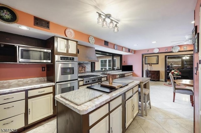 933 River Rd, Hillsborough Twp, NJ 08844 - kitchen featuring appliances with stainless steel finishes, a kitchen island, light tile patterned flooring, a sink, and recessed lighting