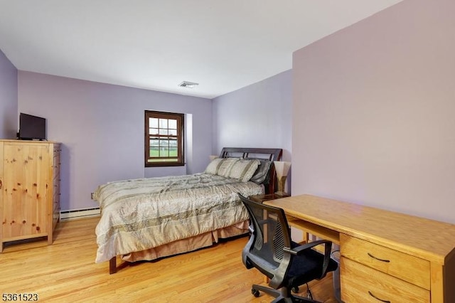 933 River Rd, Hillsborough Twp, NJ 08844 - bedroom with baseboard heating, light wood-style flooring, and a desk