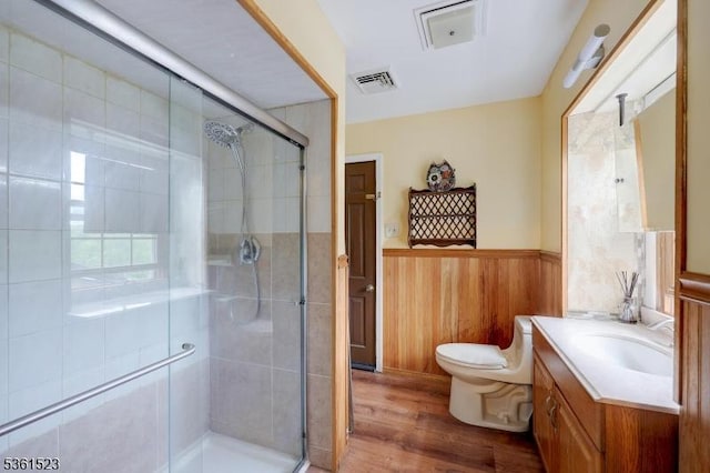 933 River Rd, Hillsborough Twp, NJ 08844 - bathroom featuring vanity, a wainscoted wall, wood finished floors, toilet, and a stall shower