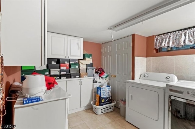 10 Hanover Ave, Hanover Twp, NJ 07981 - laundry area featuring washing machine and dryer, light tile patterned floors, and cabinet space
