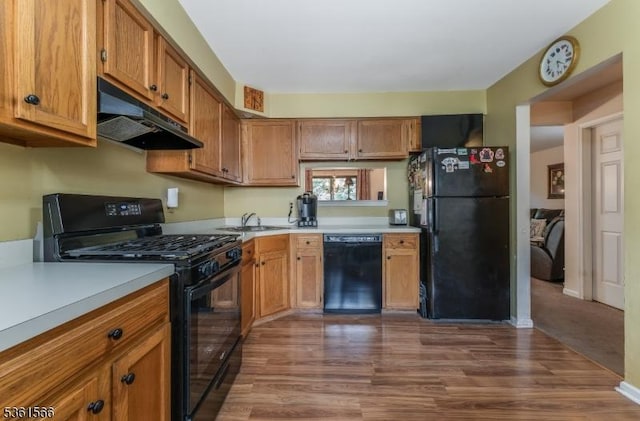 205 Burlington Ct, Raritan Twp, NJ 08822 - kitchen featuring black appliances, under cabinet range hood, dark wood-style flooring, and light countertops