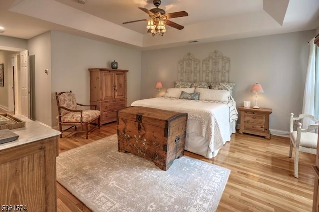 302 Lindabury Ln, Tewksbury Twp, NJ 07979 - bedroom featuring a tray ceiling, light wood finished floors, and ceiling fan