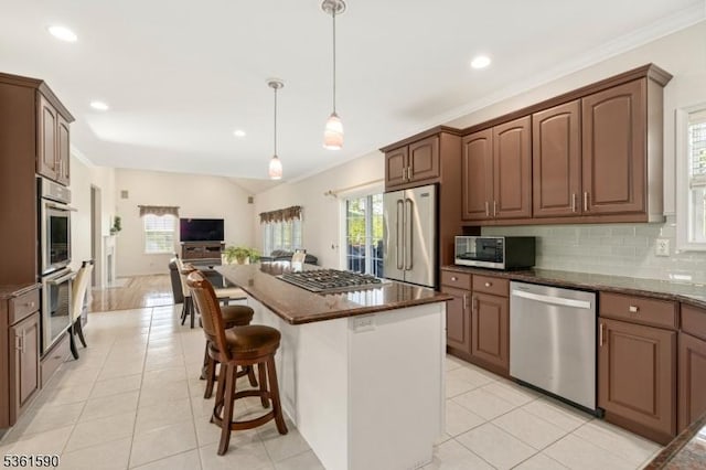 7 Links Ct, Sparta Twp, NJ 07871 - kitchen with stainless steel appliances, open floor plan, backsplash, light tile patterned flooring, and a kitchen island