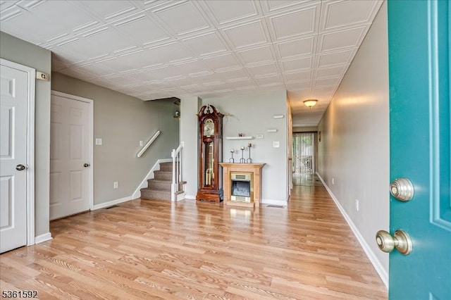73-81 Mariners Ct, Plainfield City, NJ 07063 - unfurnished living room featuring light wood finished floors, stairs, and a fireplace
