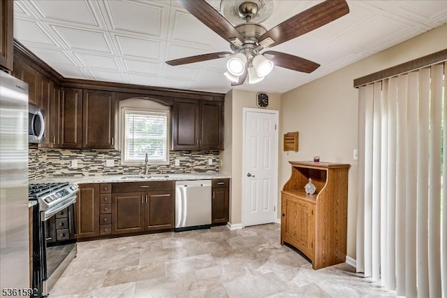 73-81 Mariners Ct, Plainfield City, NJ 07063 - kitchen featuring appliances with stainless steel finishes, decorative backsplash, ceiling fan, dark brown cabinetry, and light stone countertops