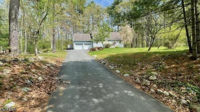 115 Tomahawk Ter, Montague Twp, NJ 07827 - view of front of house with driveway, an attached garage, and a front yard