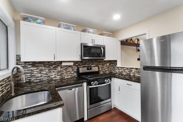 35 Bennington Sq, Washington Twp, NJ 07840 - kitchen featuring appliances with stainless steel finishes, open shelves, white cabinets, backsplash, and dark stone counters