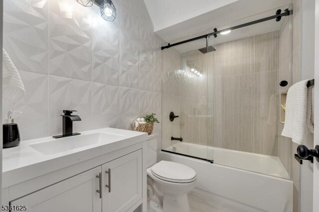 139 Weaver Ave, Bloomfield Twp, NJ 07003 - full bathroom featuring combined bath / shower with glass door, tile walls, toilet, and vanity